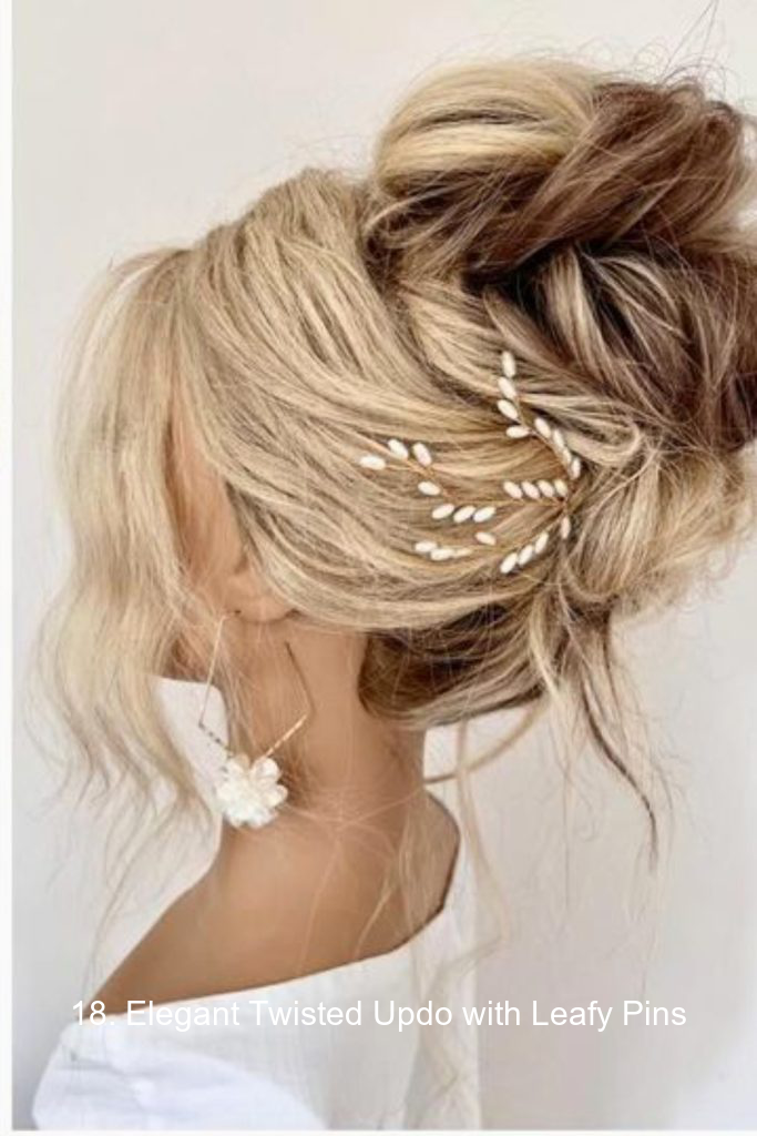 18. Elegant Twisted Updo with Leafy Pins