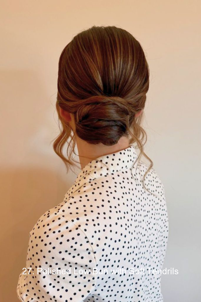 27. Polished Low Bun with Soft Tendrils