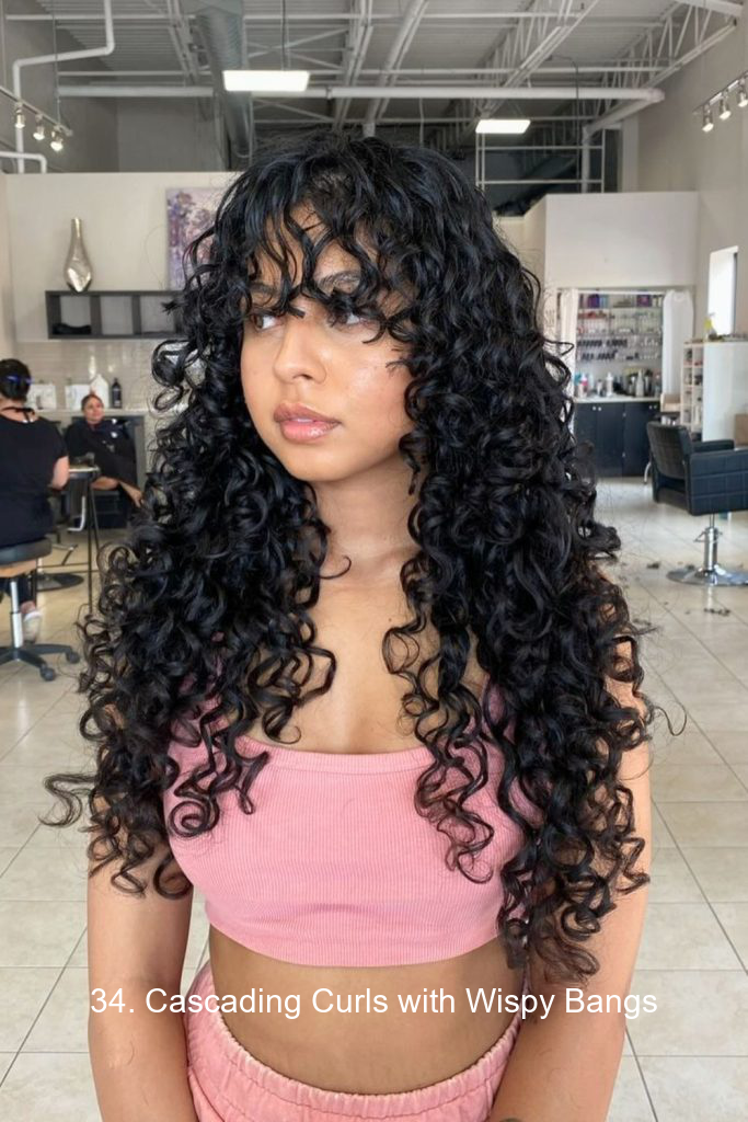 34. Cascading Curls with Wispy Bangs