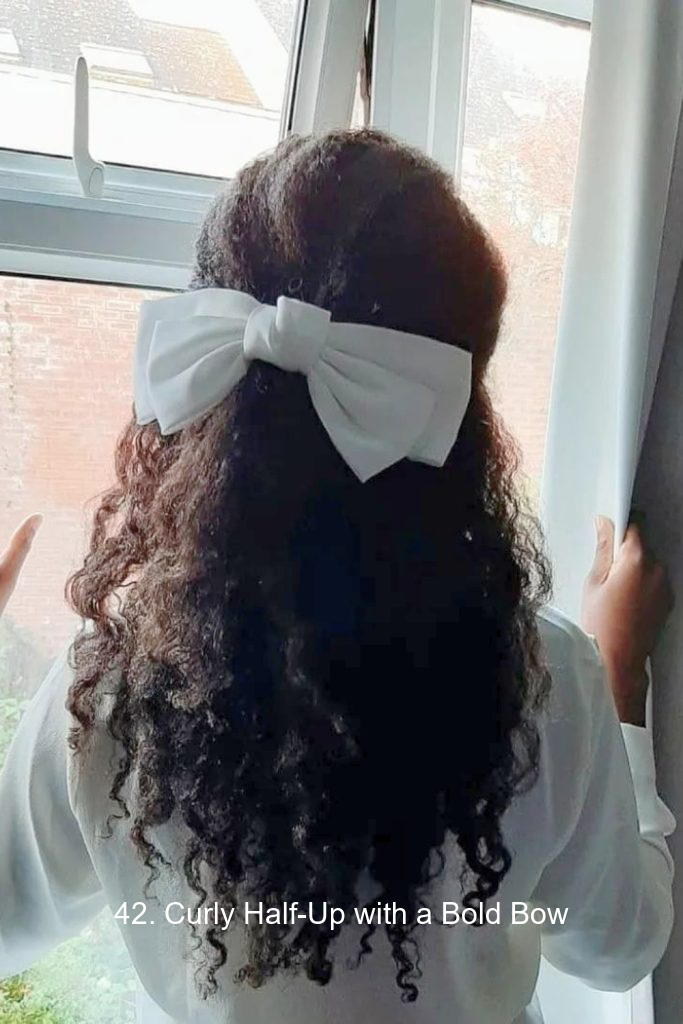 42. Curly Half-Up with a Bold Bow
