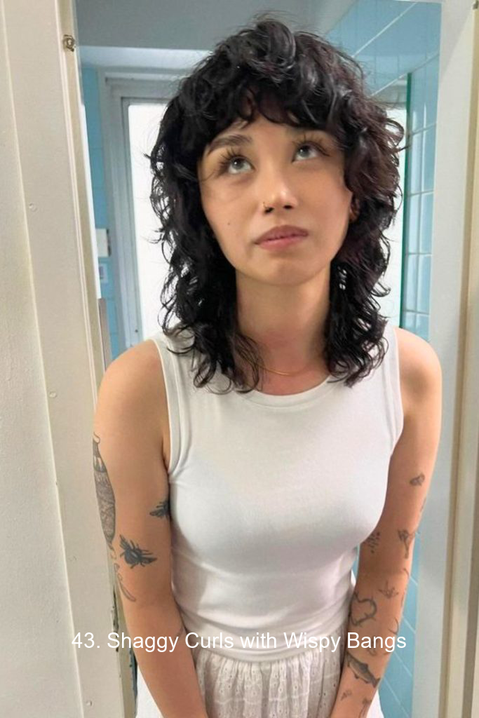 43. Shaggy Curls with Wispy Bangs