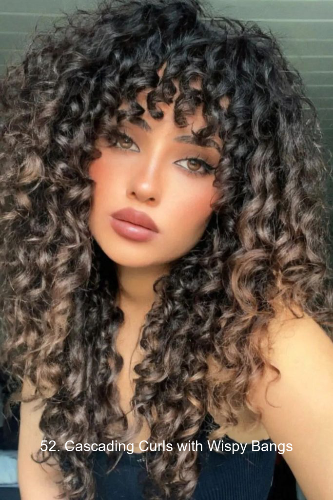 52. Cascading Curls with Wispy Bangs